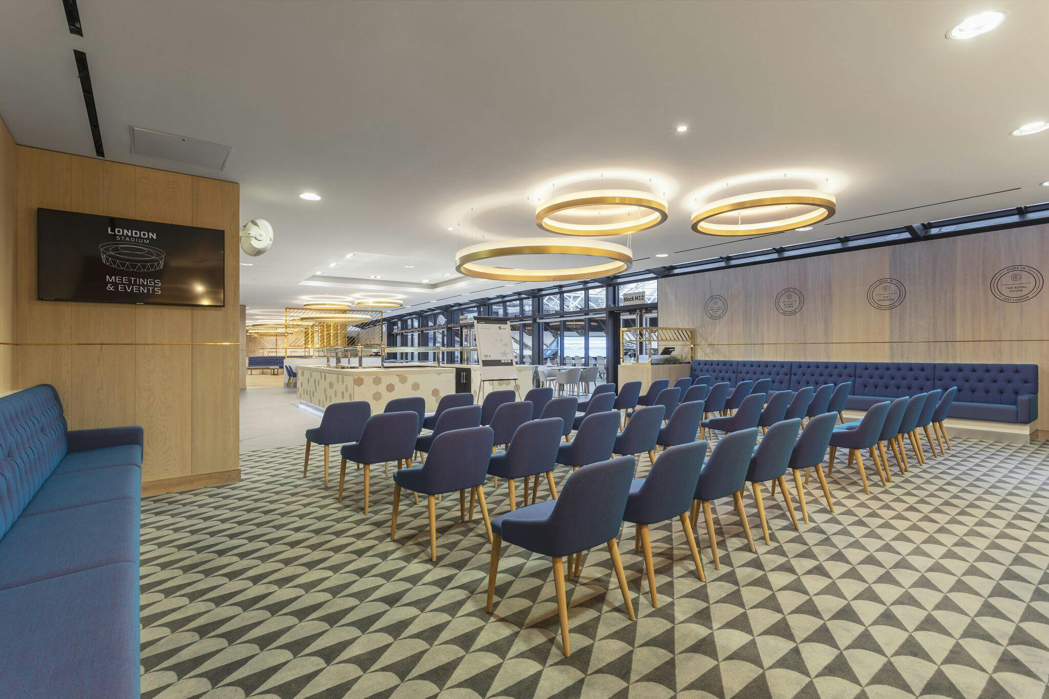 Modern event space at The Royal East, London Stadium, ideal for presentations and workshops.