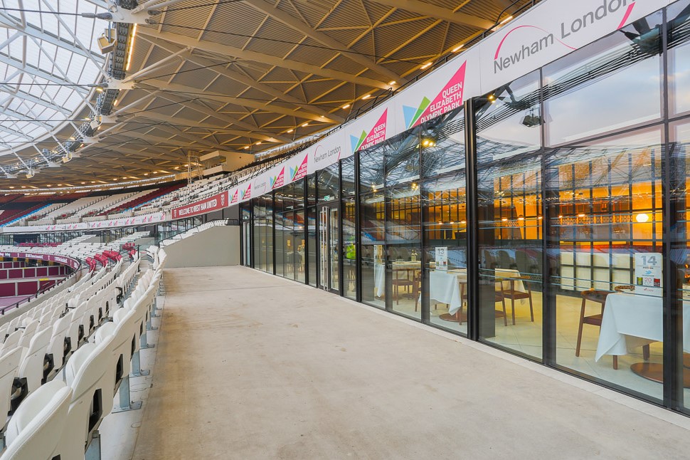 Modern event space in London Stadium with glass walls, ideal for corporate events. - Banner