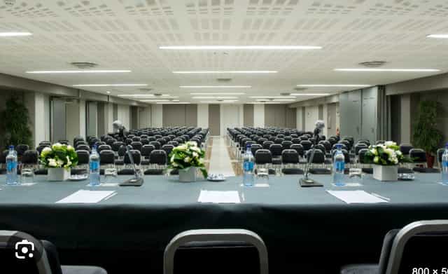 Conference room at Altis Grand Hotel with floral centerpieces for meetings and workshops.