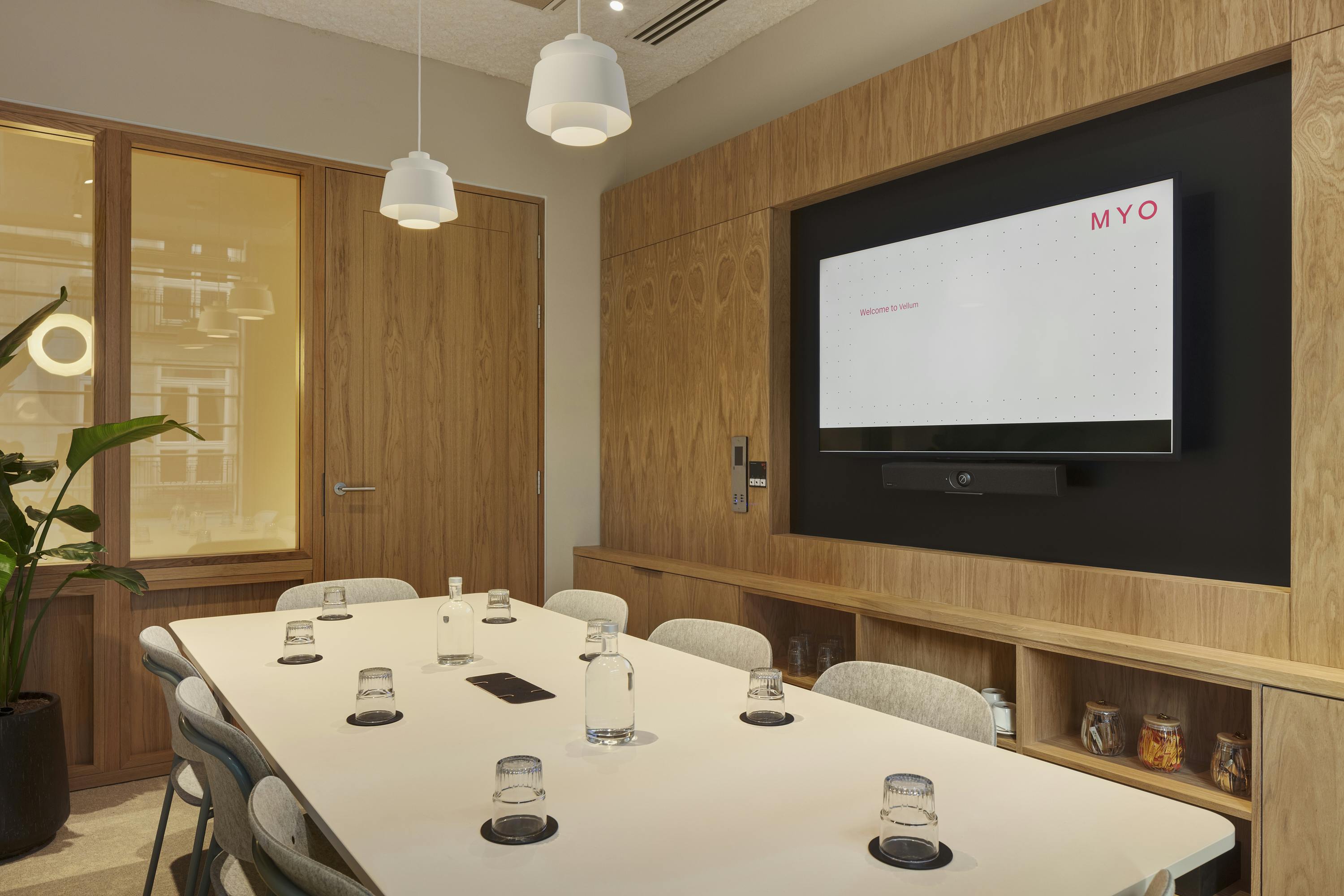 Modern meeting room with sleek table, ideal for collaboration and presentations.