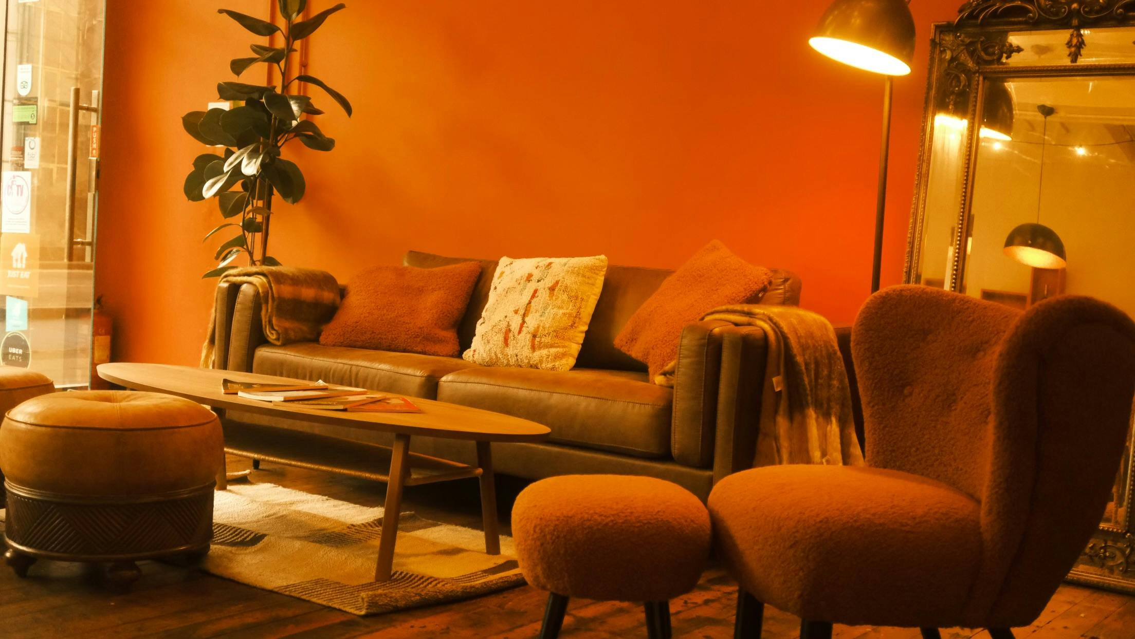 Cozy lounge in The Hub's Orange Room, ideal for networking events and meetings.