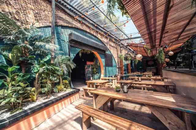Vibrant outdoor venue with lush greenery for casual meetings and events.