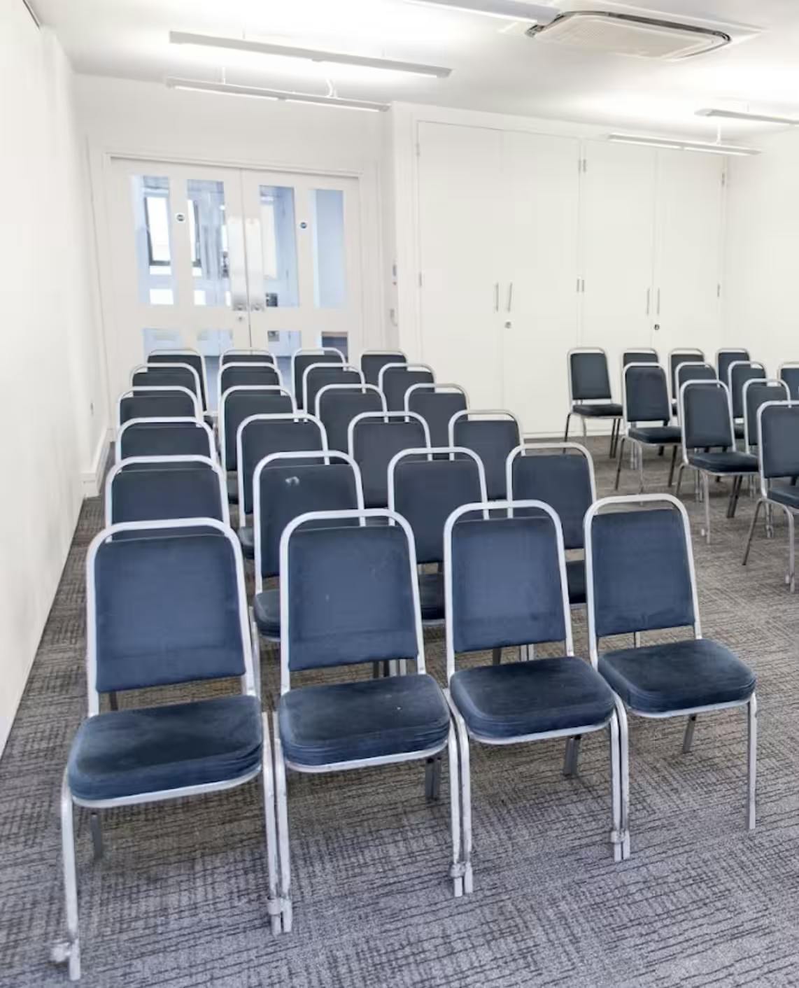 Ruby Suite in Rock Tower with empty chairs set for a professional event setup.