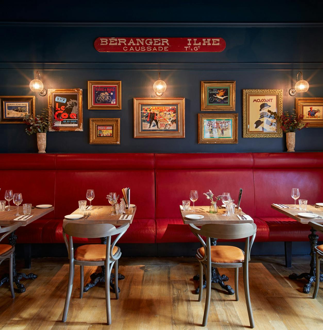 Stylish dining area with red seating at Bistrot Pierre Leicester for events and gatherings.