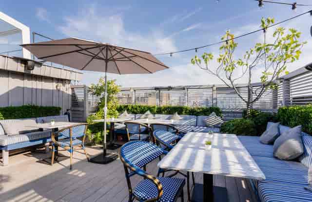 Stylish rooftop venue with retractable glass roof for outdoor conferences and events.