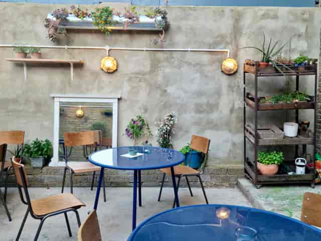 Charming outdoor venue with rustic wall, ideal for intimate gatherings and events.