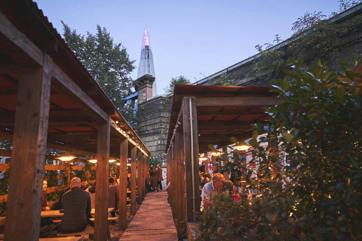 Flat Iron Square outdoor venue with rustic wood, ideal for events and alfresco dining.