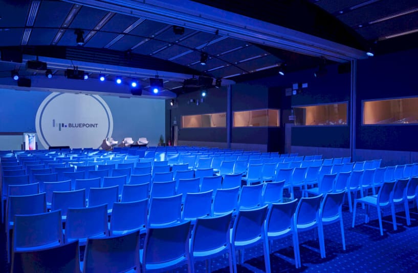 Modern event space at Einstein ABC, Bluepoint Brussels with ambient blue lighting.