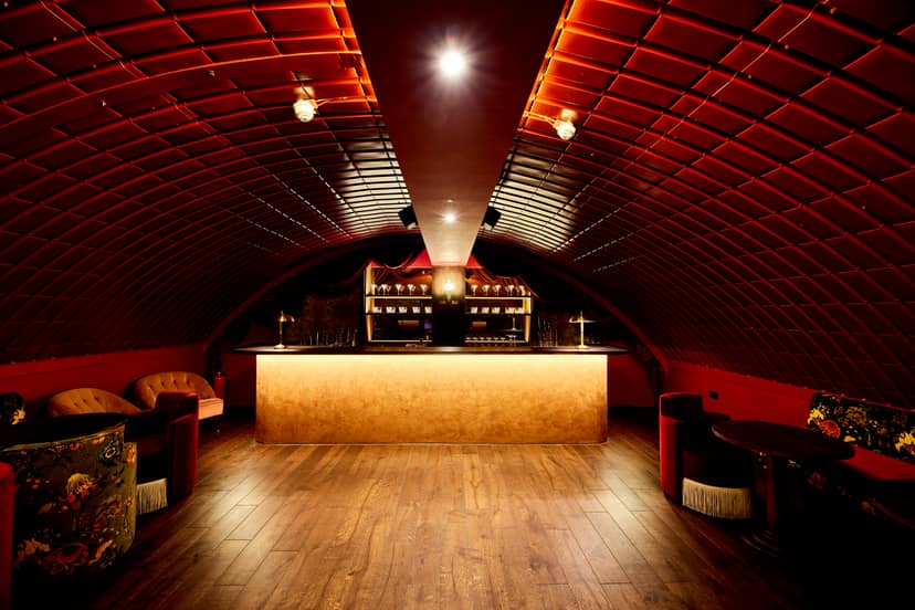 Stylish event space at Rae's in Omeara with arched ceiling, ideal for upscale gatherings.