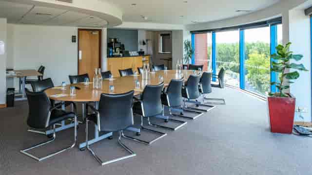 Srivikorn Suite meeting room with oval table, ideal for professional gatherings and events.