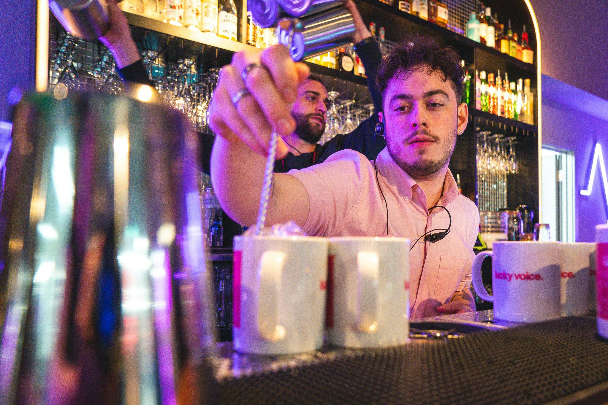 Dynamic bar setup with skilled bartenders at Lucky Voice Waterloo event.