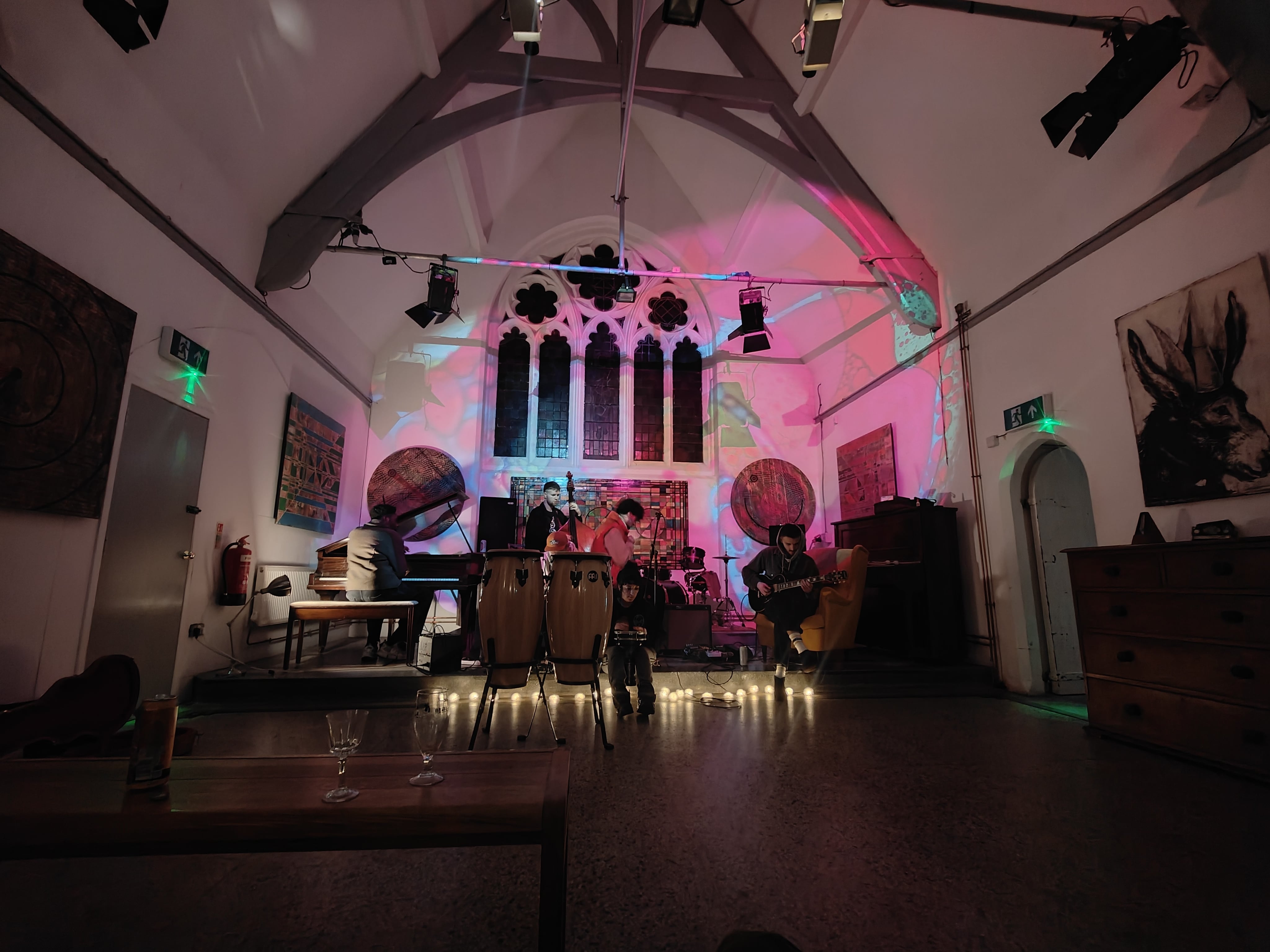 Vibrant St Dunstans House event space with colorful lighting for live music gatherings. - Banner