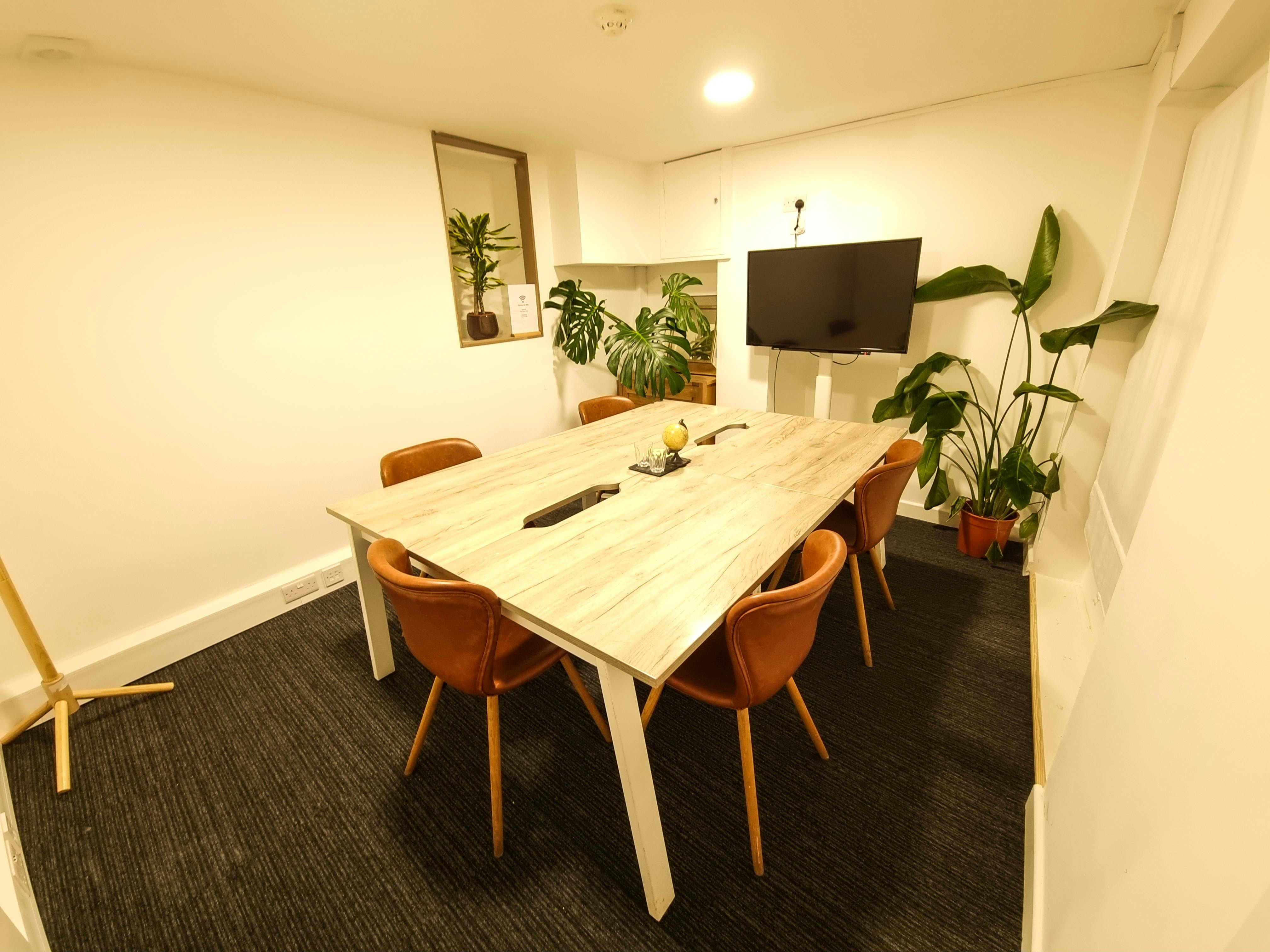 Modern meeting room with wooden table, ideal for collaborative business meetings.