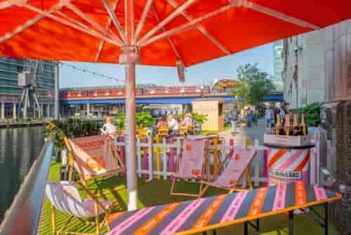 Vibrant outdoor event space with colorful lounge chairs at Summer Terrace, Fairgame.