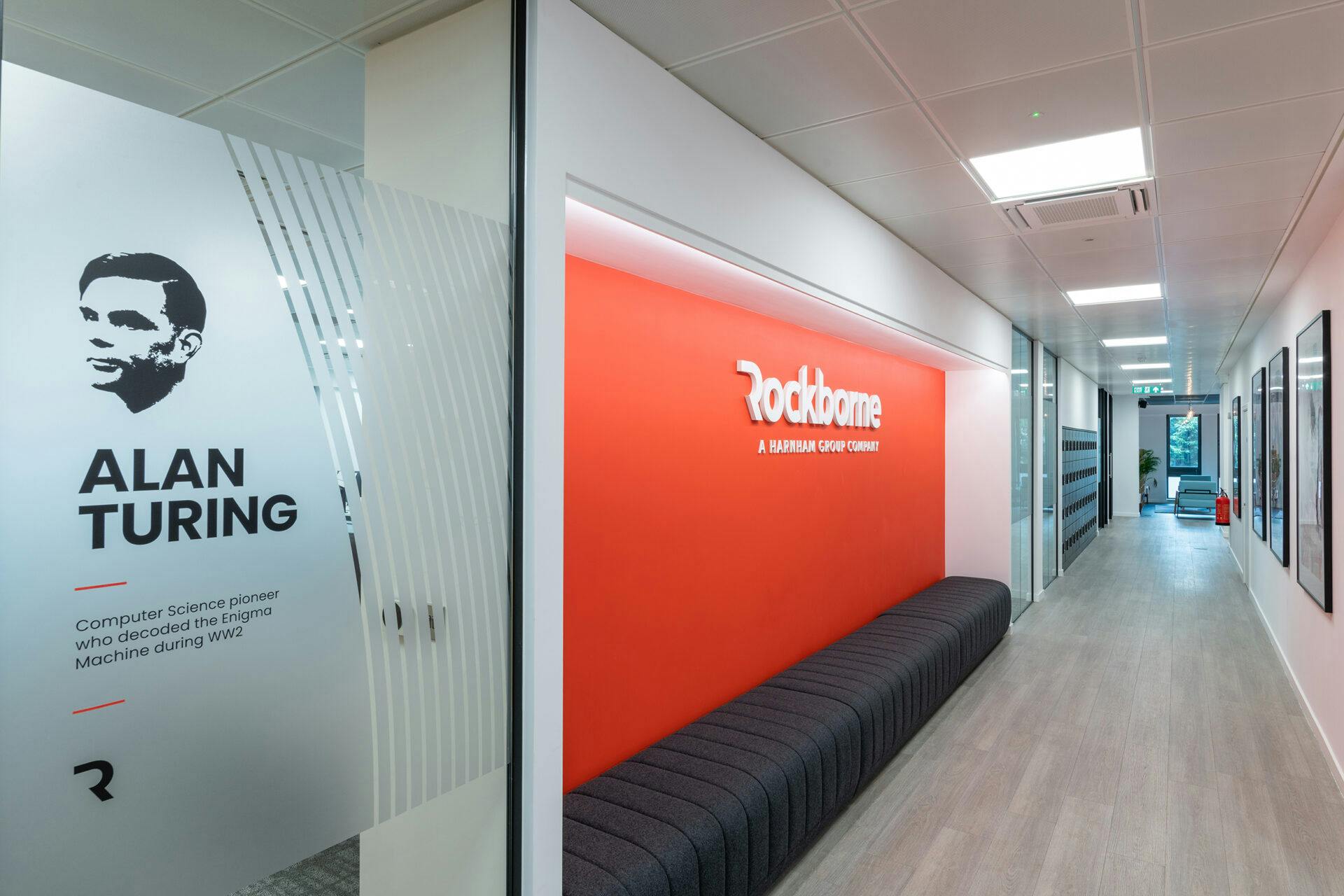 Modern office corridor with Alan Turing's portrait, ideal for creative meetings and events.