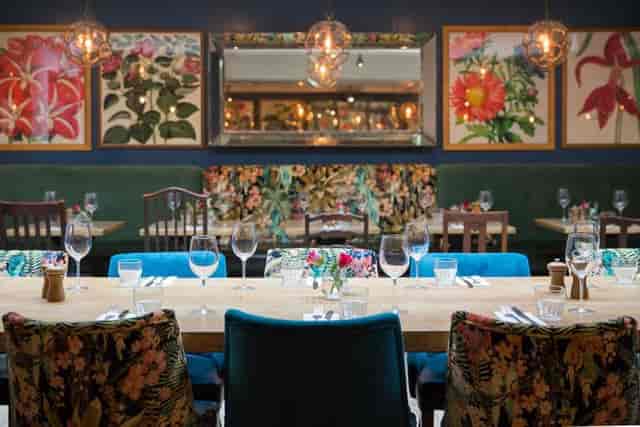 Vibrant dining room with floral decor for intimate gatherings and corporate events.