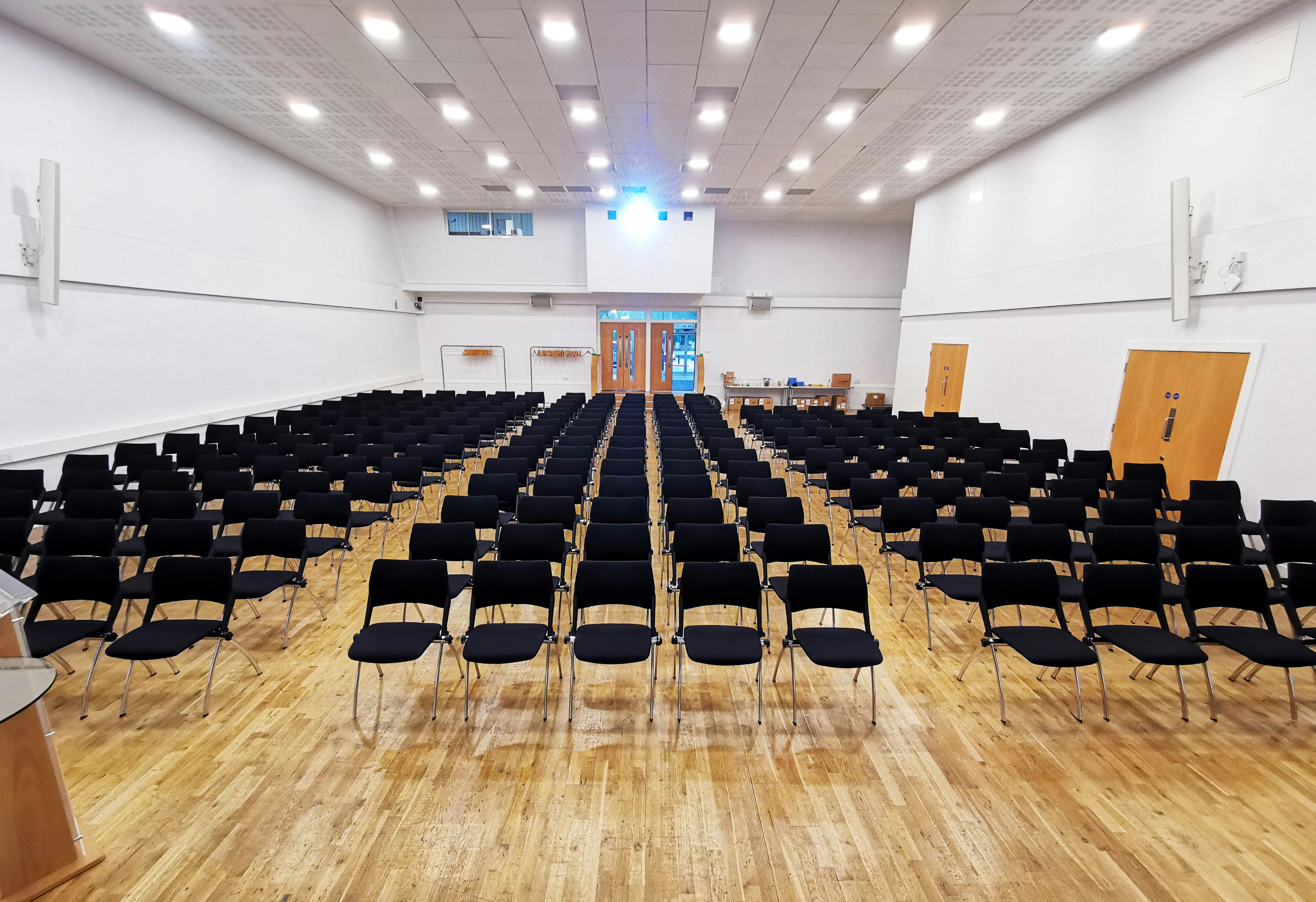Event Hall at MPW Queen's Gate House with black chairs for a seminar setup. - Banner