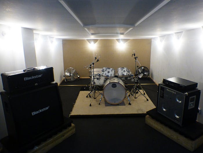 Rehearsal room in K-Town Studios with professional drum set for music events.