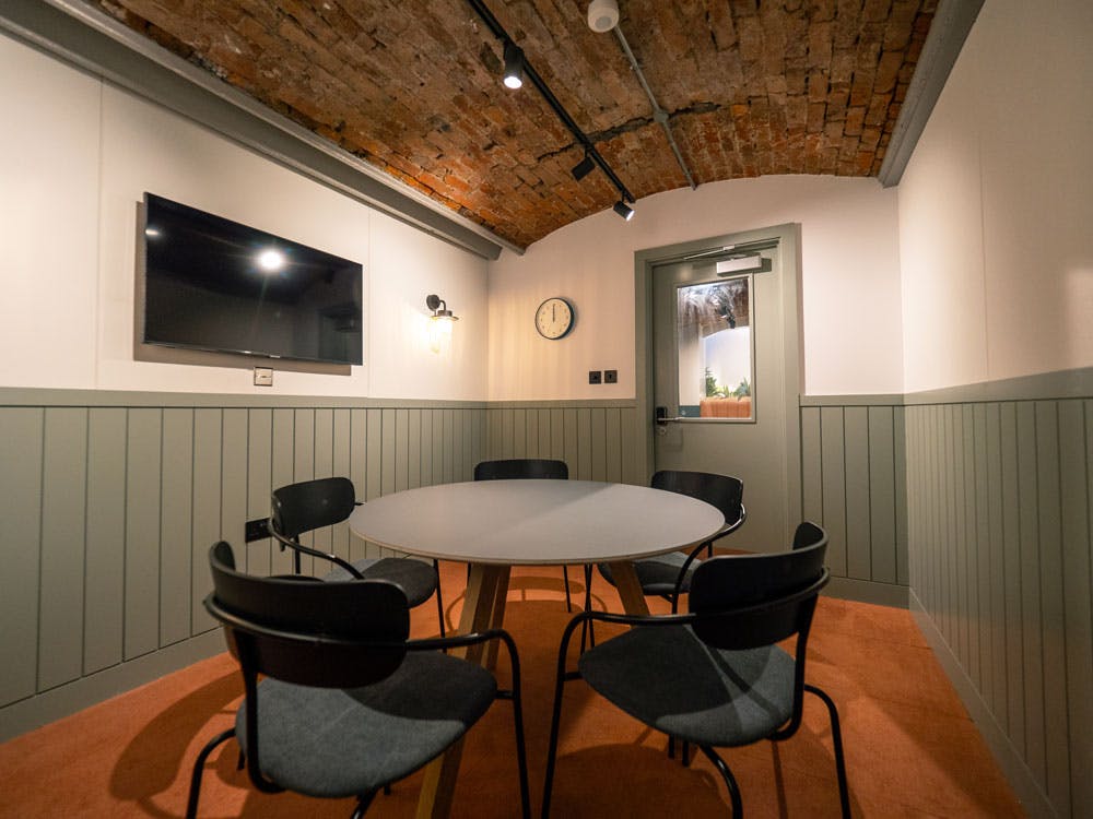 Modern meeting room with round table, ideal for brainstorming sessions and team meetings.