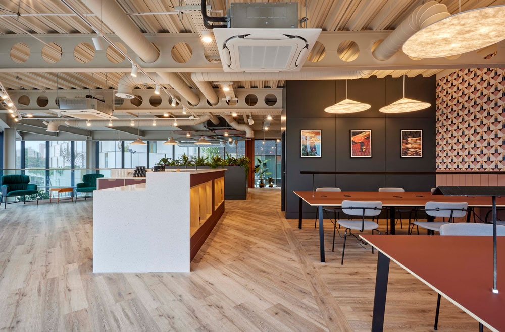 Modern meeting room with pendant lighting, ideal for networking events and casual meetings. - Banner