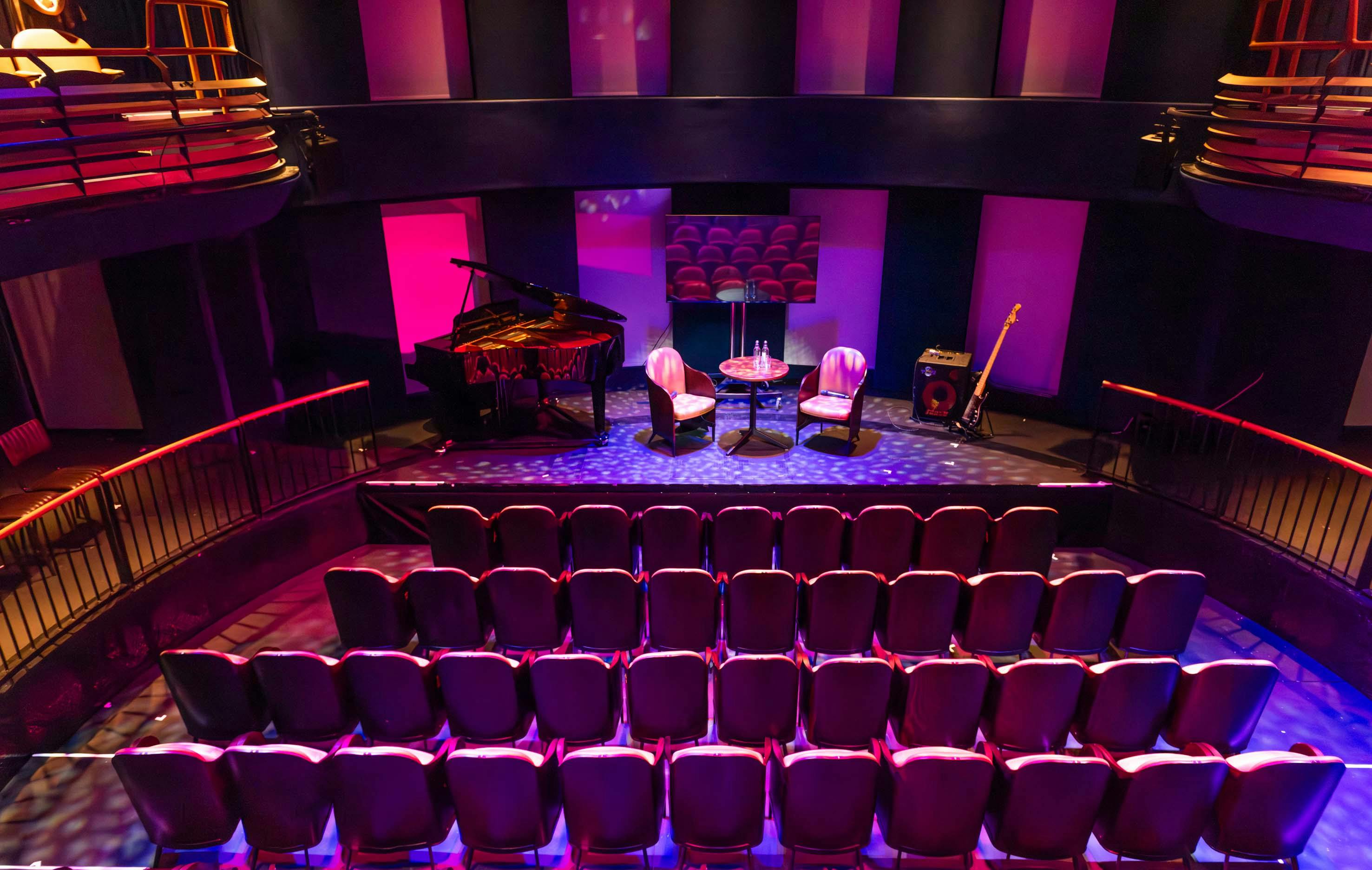 Intimate event space with stage, ideal for workshops and live performances.