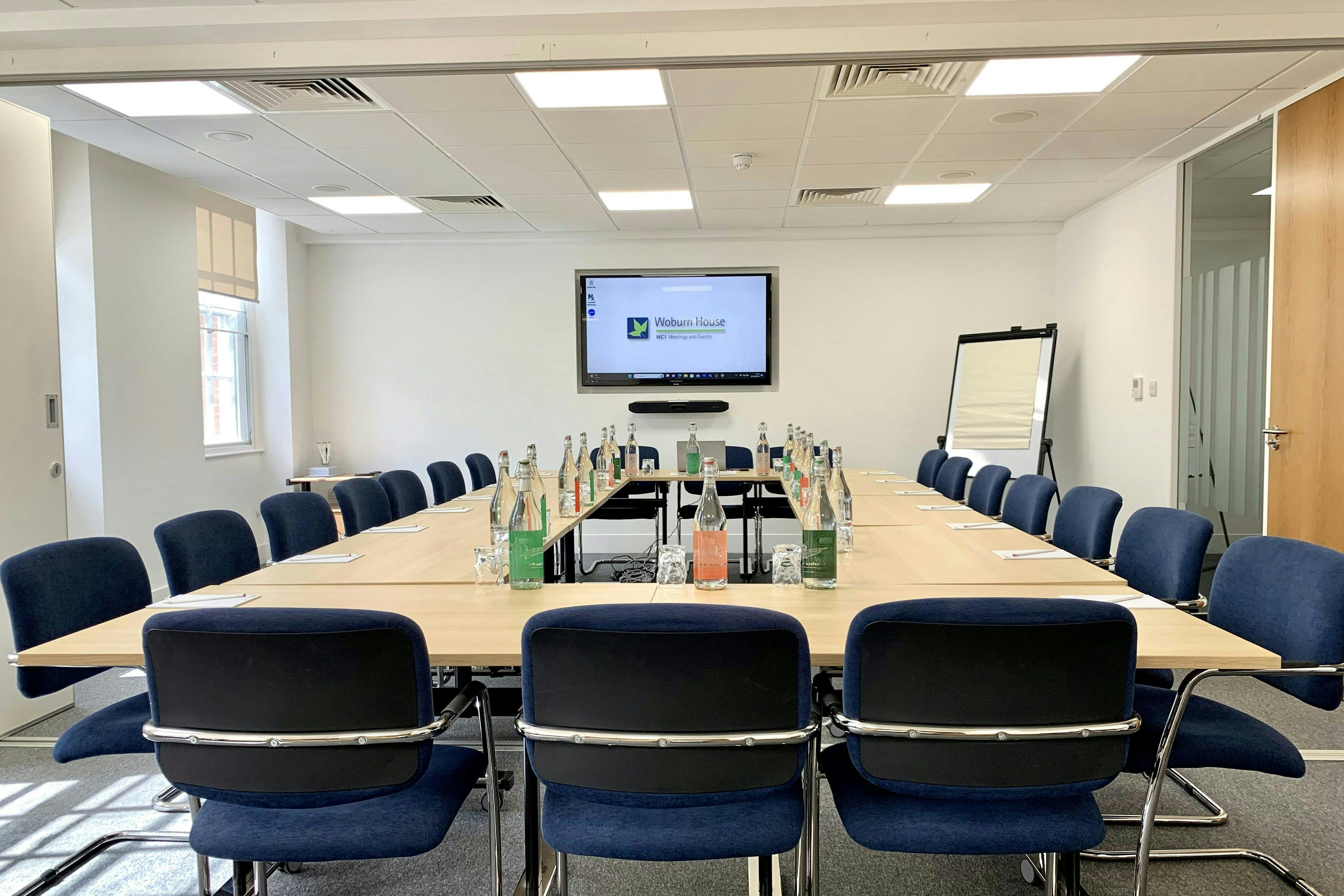 Brunswick Room at Woburn House: spacious meeting room with large table, ideal for conferences.