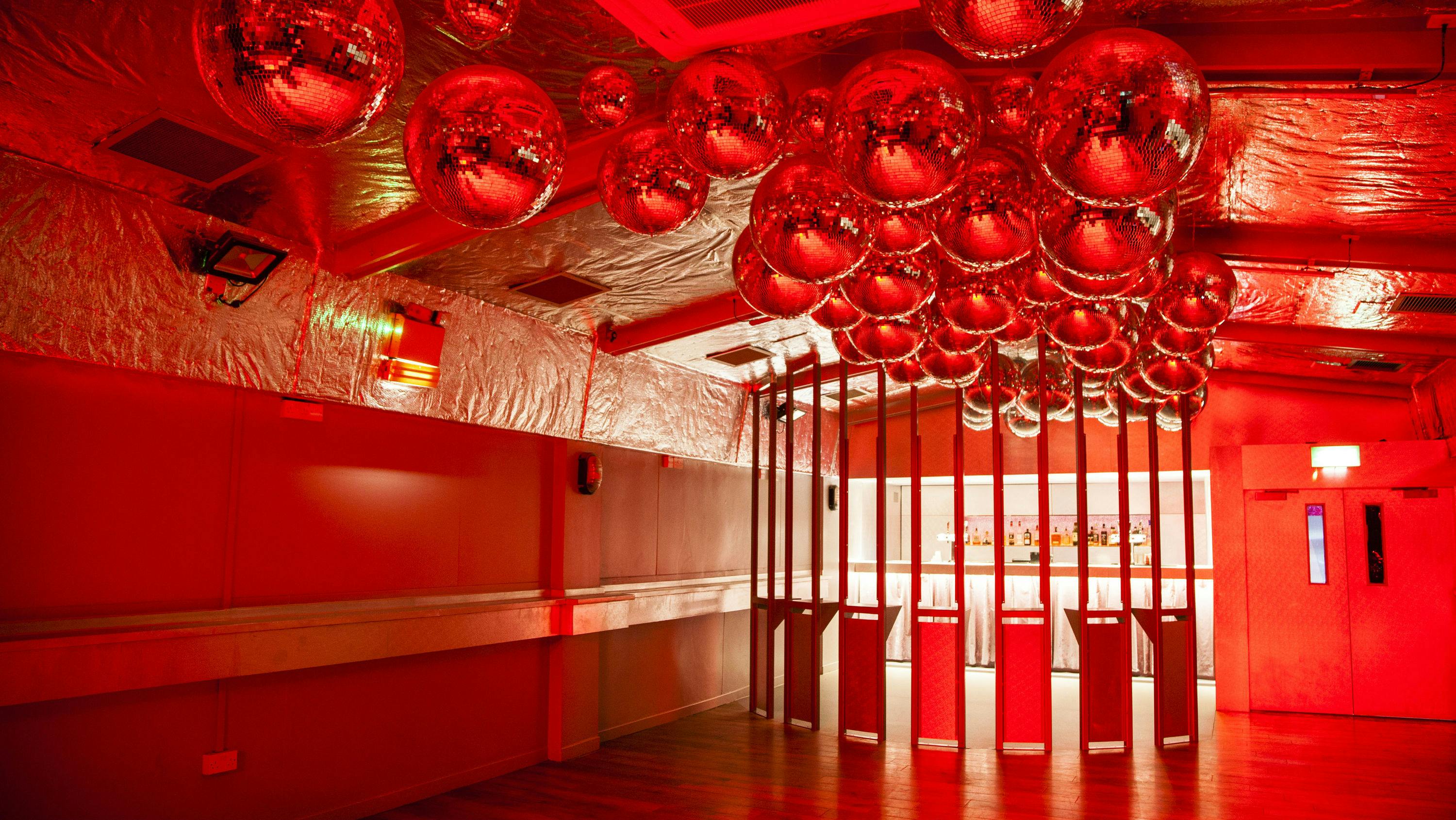 Vibrant event space with mirrored disco balls, ideal for parties and social gatherings.