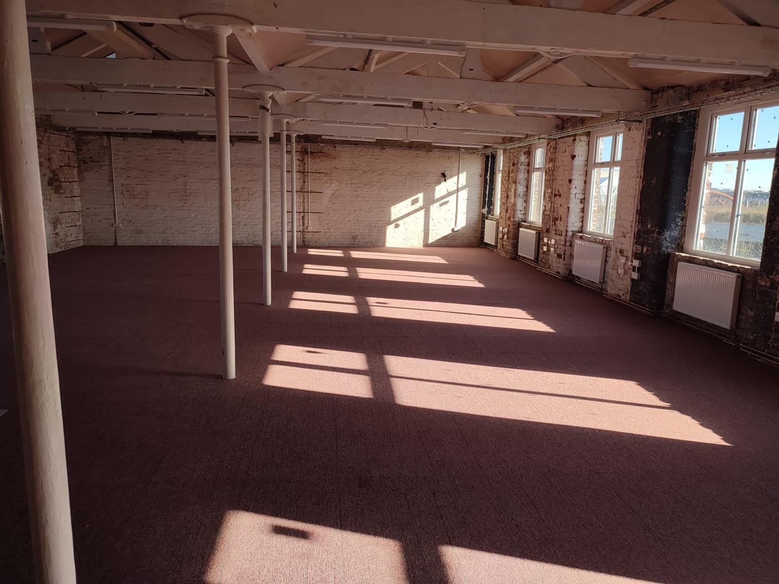 Spacious New Islington Mill venue with natural light, perfect for creative events and workshops.