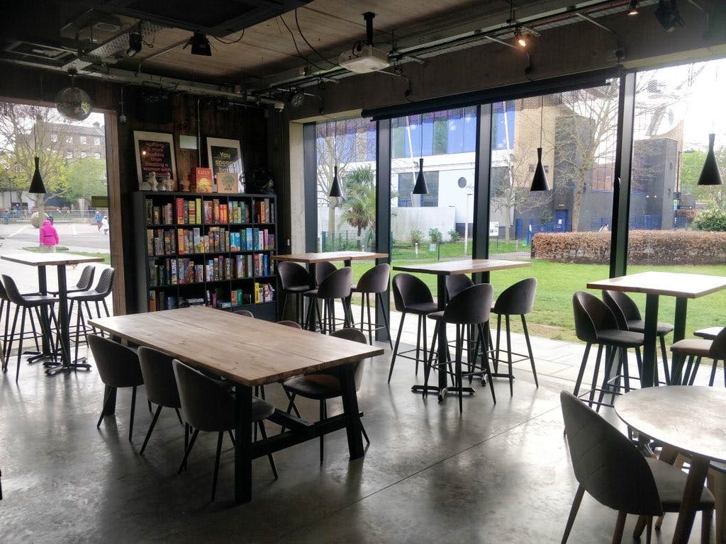 Modern event space with natural light, ideal for workshops and casual meetings.