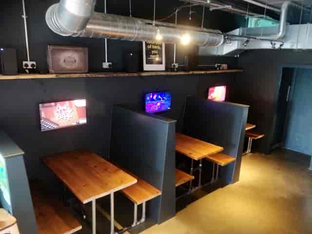 Modern meeting space with wooden tables and screens at Loading Bar Peckham.