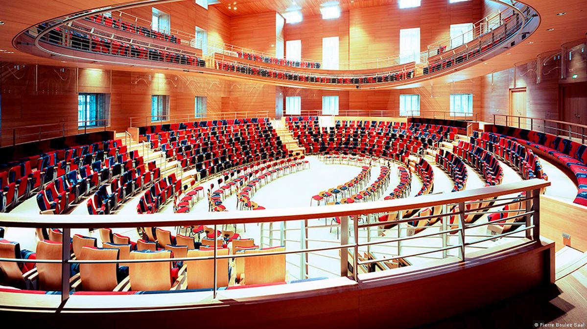 Modern concert hall with tiered seating, perfect for conferences and presentations.