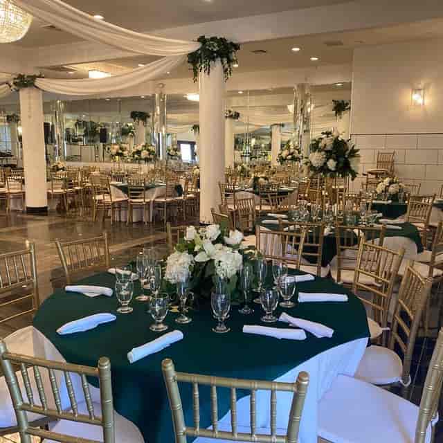 Elegant Saint Mina Banquet Hall with green tables, perfect for weddings and formal events.