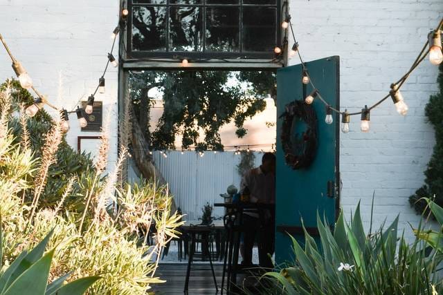 Charming outdoor courtyard with string lights, ideal for intimate gatherings and events.