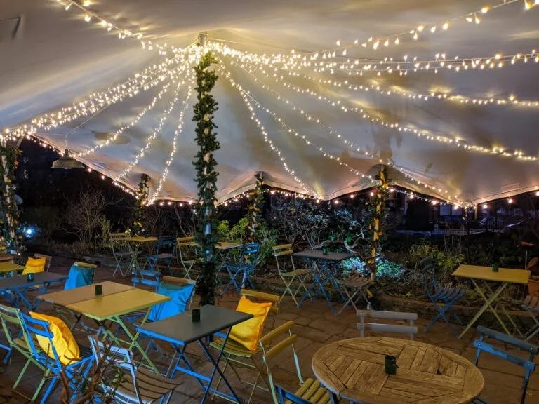 Burgh House Café outdoor event space with string lights, perfect for gatherings and networking.