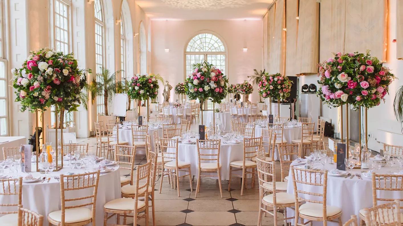 Banquet setup at The Orangery, Kew Gardens with elegant floral centerpieces for luxury weddings. - Banner