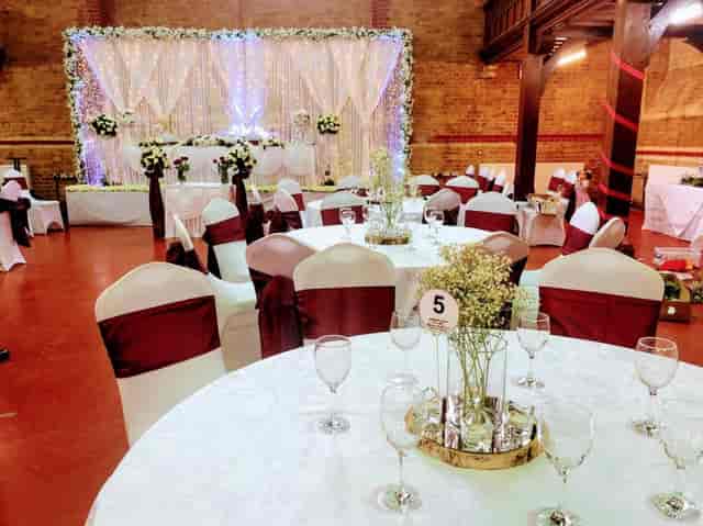 Elegant wedding venue with floral centerpieces and twinkling lights in Wheatsheaf Hall.