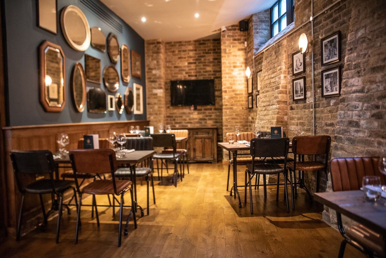 Stylish games room with warm lighting, ideal for private events and meetings. - Banner