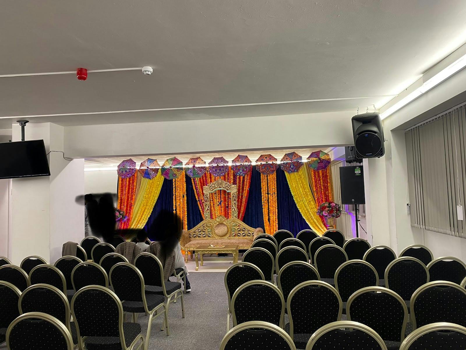 Kingfisher Hall event space with vibrant drapery for weddings and cultural celebrations. - Banner