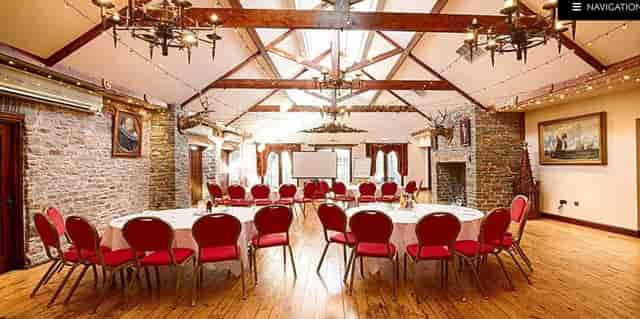 Miskin Manor Hotel event space with round tables, ideal for meetings and celebrations.