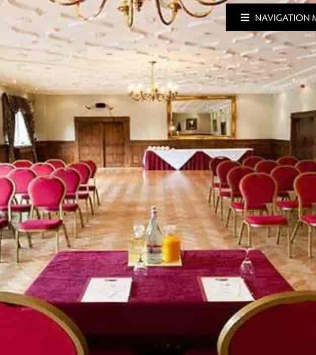 Miskin Manor Hotel meeting room with red chairs, perfect for seminars and presentations.