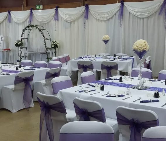 Elegant event space in EastendHomes, perfect for weddings with white and purple decor.