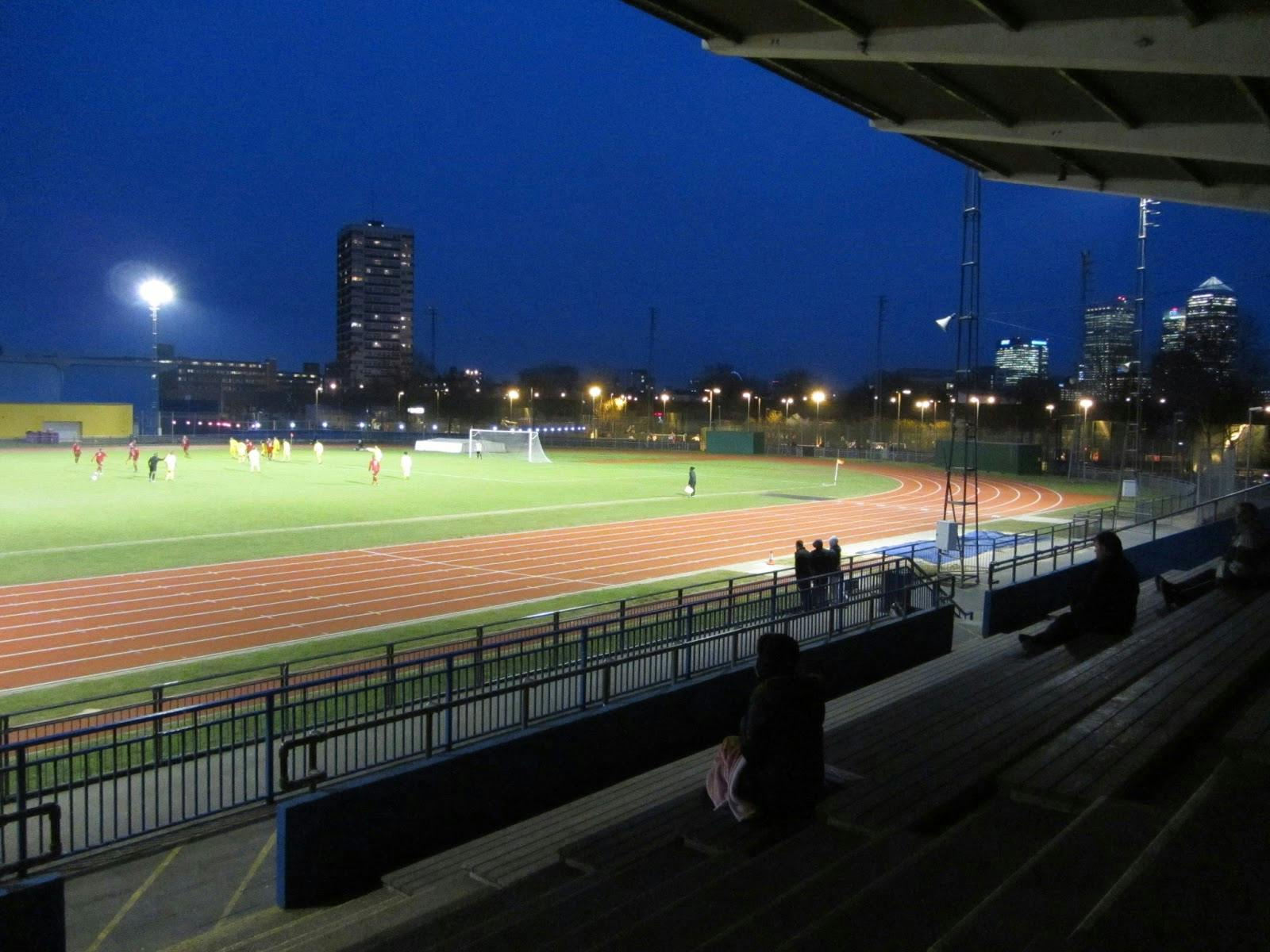 Athletics Stadium at Mile End Park, illuminated field for evening sports events.