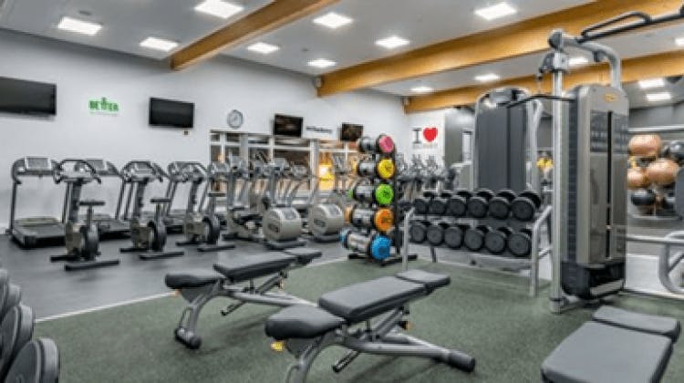 Modern gym with exercise machines in Mile End Park for wellness events and team-building.