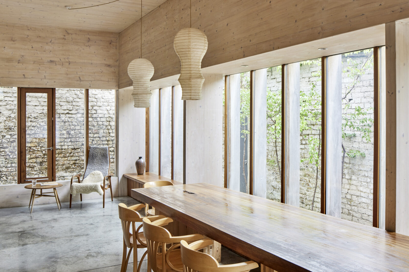 Modern meeting space with wooden table and natural light at Evelyn Community Centre. - Banner