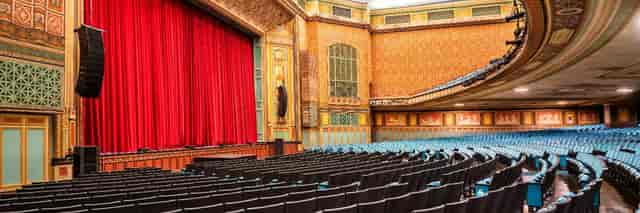 Elegant stage with red curtains at Pasadena Convention Center for events and performances.