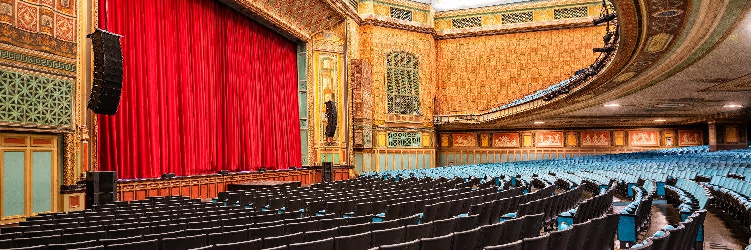 Grand stage with red curtains at Pasadena Convention Center for events and performances.
