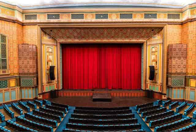 Pasadena Convention Center stage with red curtain, ideal for conferences and performances.