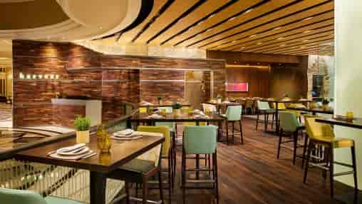 Modern dining lounge with warm wood tones, perfect for events and meetings.
