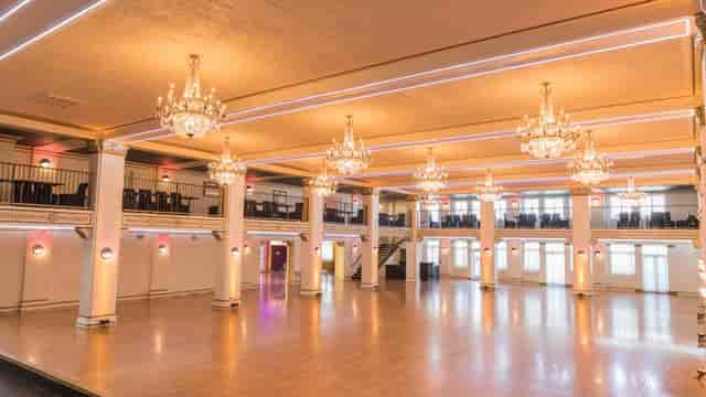 Penthouse event venue with chandeliers, ideal for weddings and corporate events.