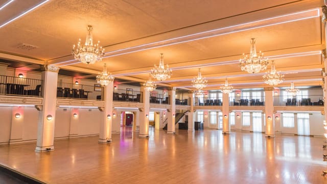 Penthouse event venue with chandeliers, ideal for weddings and corporate events.